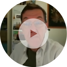 A person in glasses and a collared shirt is talking in what appears to be a video call or recording, with a kitchen and artwork visible in the background; they mention insights about spray foam insulation.