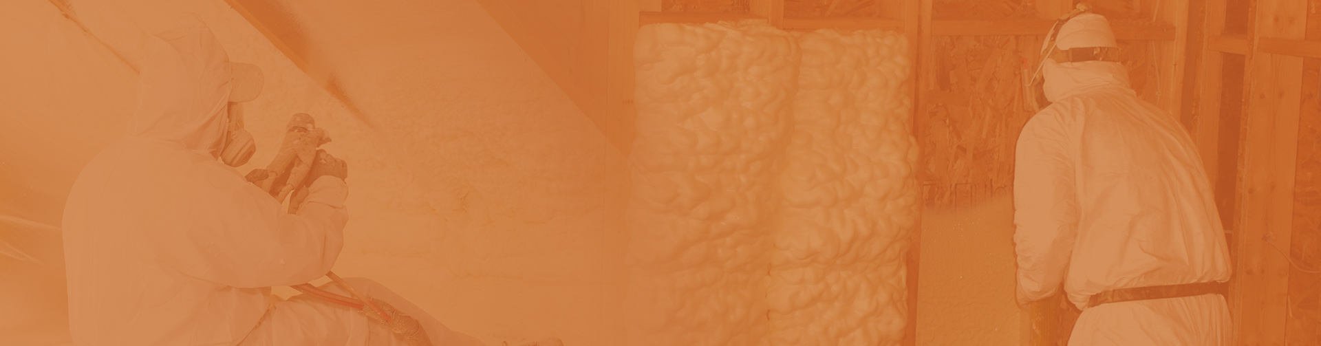 Two workers from an insulation company, clad in protective gear, are expertly applying spray foam insulation inside a building.