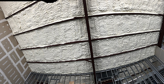 Image showing a close-up view of a metal structure with spray foam insulation applied in several horizontal sections. The background includes partially completed drywall panels, indicative of the meticulous work by an insulation company Baton Rouge trusts for quality.
